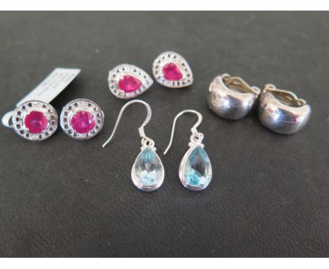 Four pairs of earrings - To include two pairs set with ruby and diamond - one pair set with topaz - together with a pair of e