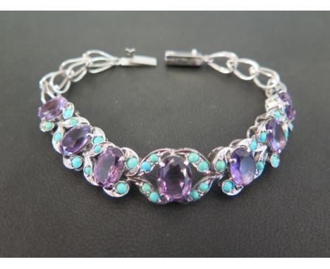 An amethyst and turquoise panel bracelet - Length approx 20cms
Condition Report: Good - Mounted in white metal
