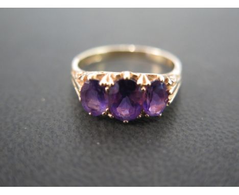 A 9ct gold amethyst three-stone ring - Hallmarked London - Ring size O - Weight approx 2.9gms
Condition Report: Good to fair 