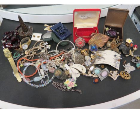 An assortment of vintage, silver, costume jewellery and watches