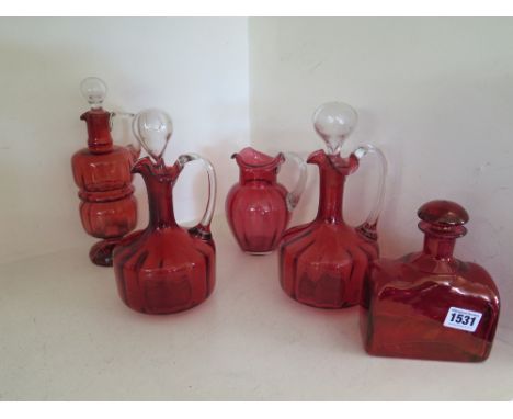 A group of five 19th century and later Cranberry and ruby glass jugs and decanters including a pair of claret jugs, pontil ma