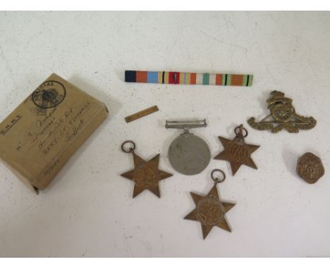 A group of four un-named World War II medals with box and ribbons - M Dobson - a 1st Army ribbon badge and two Artillery badg