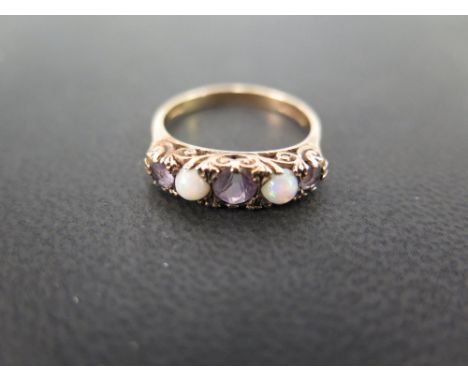 A 9ct gold opal and amethyst five-stone ring - To the carved gallery and plain band - Hallmarked London - Ring size O - Weigh