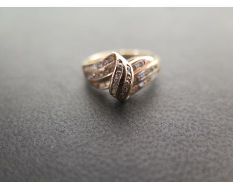 A three-row white-gem twist ring - Stamped 9ct - Ring size K - Weight approx 2.7gms
Condition Report: Good - With light surfa