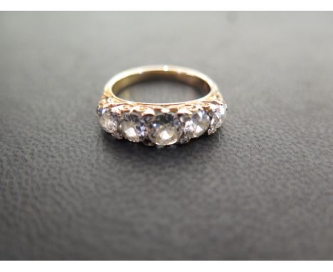 An old-cut diamond graduated five-stone ring - With rose-cut diamond highlights to the carved gallery and plain band  - Estim