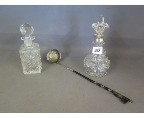 A T oddy ladle inset with a George II coin and whalebone handle tests as silver, a small decanter with rim tests as silver an