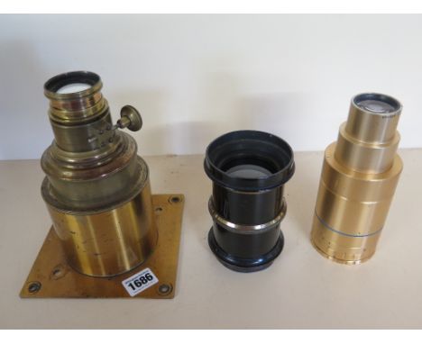 Two large vintage brass Camera lenses and an Anamorphic lens