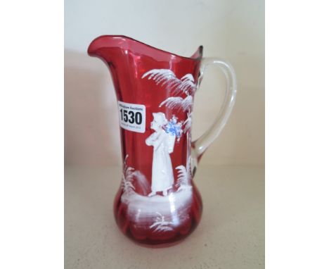 A pretty Mary Gregory Cranberry jug with clear glass handle featuring a young women with basket of flowers on her back with h