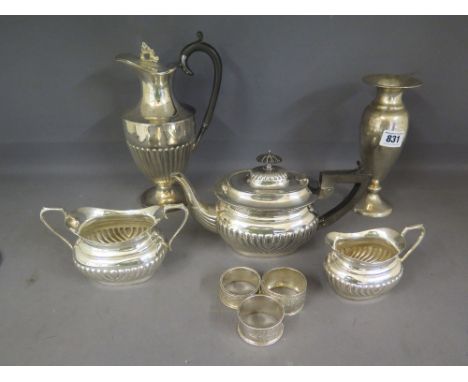 A silver weighted baluster form vase, three early 20th century napkin rings and a silver plated tea service and a plated wate