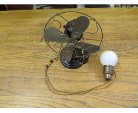 A small vintage Bakelite fan and a switch light bulb