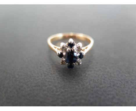 A sapphire and diamond cluster ring - Stamped 18ct - Ring size K - Weight approx 3.1gms
Condition Report: Good to fair - With