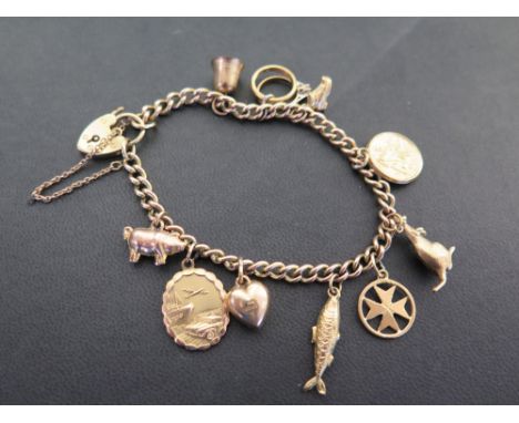 A 9ct gold curb-link bracelet suspending ten assorted charms - Hallmarked Birmingham - Length 19cms - Weight approx 23.0gms
C