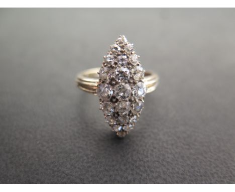 A diamond cluster ring - Of marquise outline set throughout with old-cut diamonds to the grooved band - Estimated total diamo