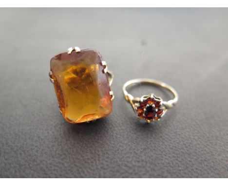 A 9ct gold garnet cluster ring - Hallmarked Birmingham - Ring size L - Together with a paste single-stone ring - Tests as 9ct