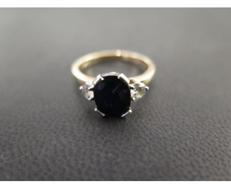 A 9ct gold sapphire and diamond three-stone ring - Estimated total diamond weight 0.20ct - Hallmarked London - Ring size O 1/