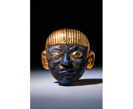 Peru, Ca. 1st century BC. A gold head with a lapis lazuli face. The hair and ears are rendered in gold, with the hair featuri