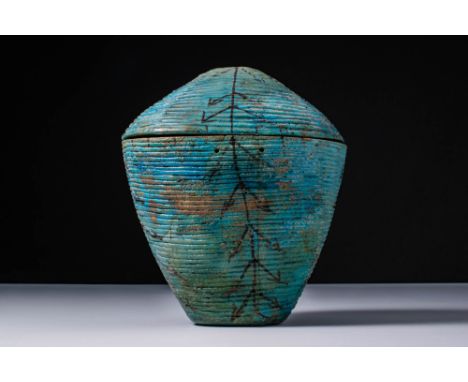 New Kingdom, Ca. 1550 - 1069 BC.A turquoise glazed faience vessel with a tapering lower section and a domed lid, both covered