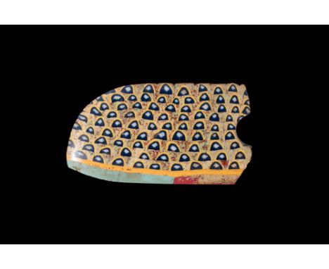 Ca. 30 BC - AD 200. A fragmentary mosaic glass inlay with a repeating pattern of dark semicircles set within yellow frames. T
