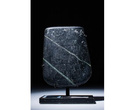 Proto Classic / Early Classic, Ca. 100 BC - AD 400. A fragment of a belt ornament carved from black stone, with an incised gl