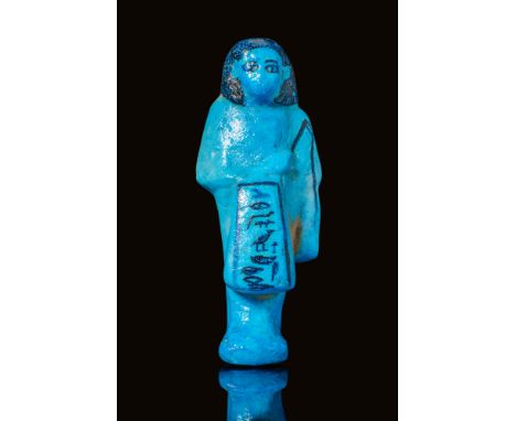 Egypt, Royal Cache at Deir el- Bahri, 21st Dynasty, Ca. 970 BC.A blue and black faience ushabti foreman in the name of Nestan