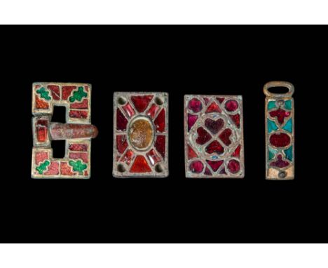 Ca. AD 400 - 600.A collection of belt buckles and decorations. The first piece is a buckle featuring a rectangular central bo