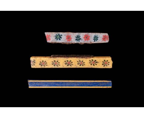 Ca. 332 BC - AD 200. A collection of three mosaic glass bars. The first from the top has a white ground with a row of alterna