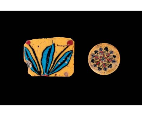 Ca. 300 BC - AD 100. A pair of glass inlays. The first, on the left, is a rectangular piece with a yellow matrix, depicting a