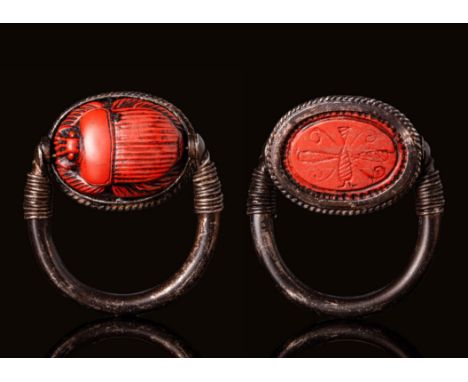 Late Period, Ca. 664 - 332 BC.A silver ring with a tubular section round hoop that tapers toward the finials. The hoop is ado