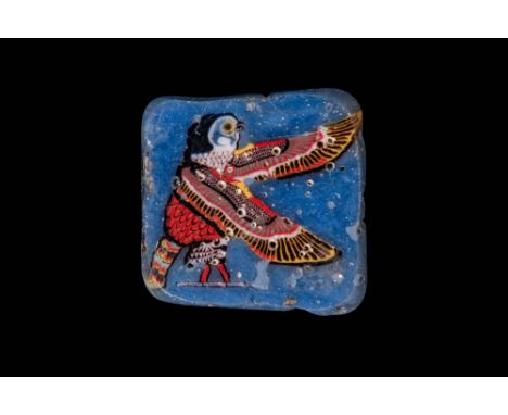Ca. 100 BC - AD 100. A mosaic glass inlay depicting Horus as a falcon, in profile, standing and facing right against a transl