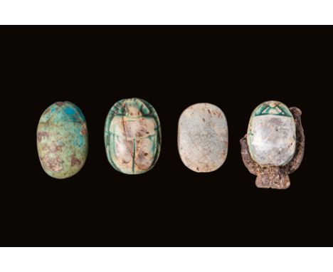 Middle Kingdom - New Kingdom, Ca. 2055 - 1069 BC.A group of four faience scarabs, all oval in shape, with three displaying de