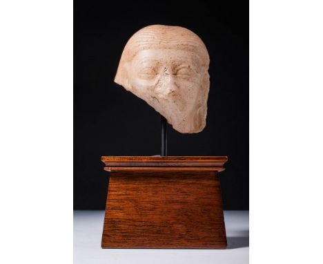 Late Old Kingdom, 6th Dynasty, Ca. 2350 - 2170 BC .A carved, finely grained stone head of a male figure. The minimal countena