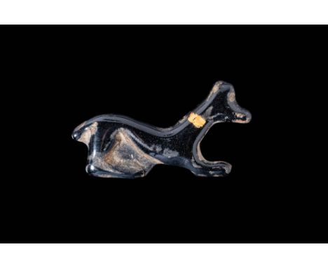Late Period to Ptolemaic, Ca. 664 - 30 BC. A glass inlay of a reclining Anubis, depicted in a simplified form with an elongat