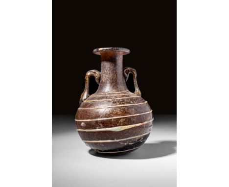Ca. 100 BC - AD 100.A brown-coloured amphoriskos with an elongated pyriform shape and tubular neck. The vessel has an everted