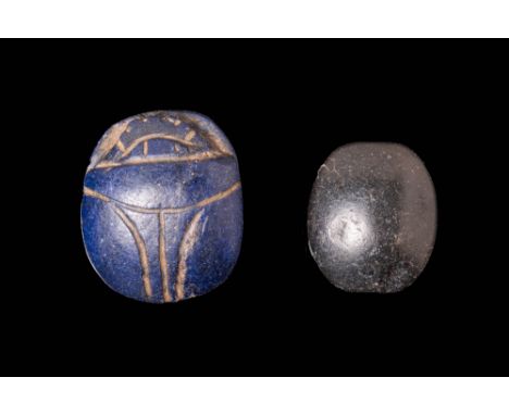 Ca. 2055 - 1069 BC.A pair of scarabs in black stone and glazed steatite of ovoid form with naturalistic features. The first i