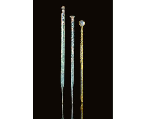 Ca. 1st - 3rd century AD. A set of three glass implements, comprising two rods and an ear pick. The first rod on the left is 