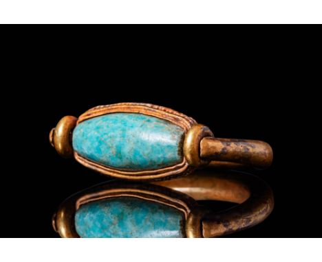 Middle Kingdom, Ca. 2055 - 1790 BC. A gold ring with a thick, rounded hoop that tapers at the shoulders. The bezel cell, flan