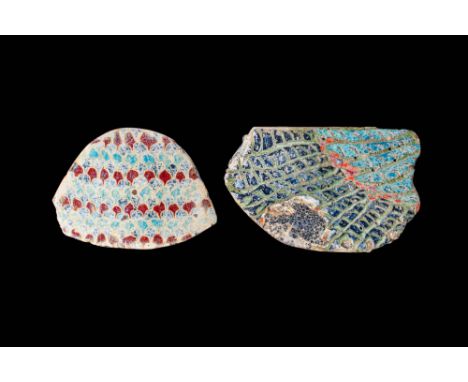 Ca. 30 BC - AD 200. A pair of fragmentary mosaic glass inlays. The first, on the left with a scale-like pattern of alternatin
