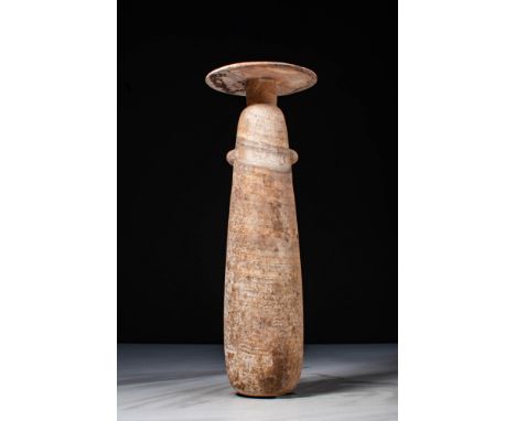 Ca. 500 - 300 BC.An alabastron carved of alabaster with a wide disc rim and elongated piriform body with a hemispheric base a