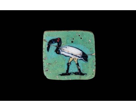 Ca. 100 BC - AD 100. A square mosaic glass inlay depicting on both faces a wading ibis against a green matrix. The bird is re