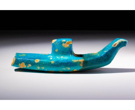 Middle Kingdom, Ca. 2040 - 1640 BC.A faience model in the form of a funerary boat. The stern of the boat curves up to the bow