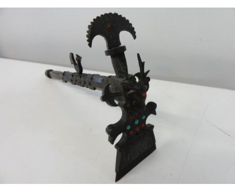 A bronze ceremonial axe with inset stones 