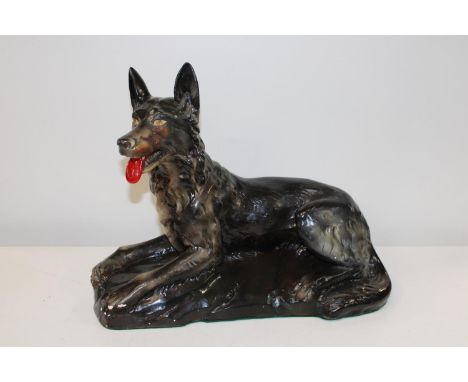A large vintage ceramic study of a German Shepard with RD mark 829298 collection only. 51cm long x 41 tall. (some very minor 