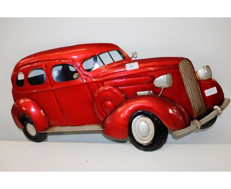 A piece of metal wall art in the form of a vintage car. 70cm x 34cm 