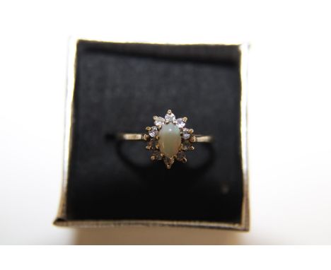 A 9ct gold central opal and diamond cluster ring size R 