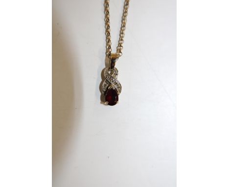A hallmarked 9ct gold chain &amp; pendant with garnet setting. 4.3 grams total 