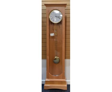 A MODERN FRANZ HERMLE & JOHN FLOOR-CLOCK in lightwood and with glazing on three sides and having a circular white dial with R