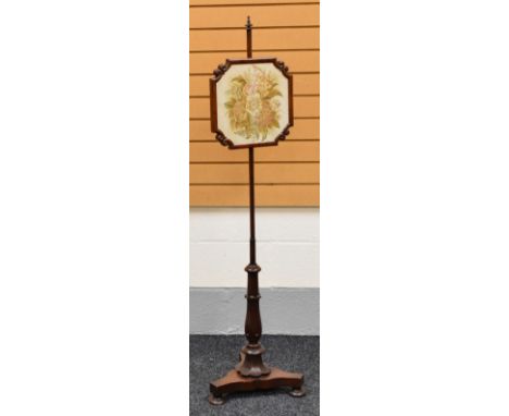 A VICTORIAN MAHOGANY POLE-SCREEN on shaped tripod base with floral column and with sliding tapestry panel in a shaped frame