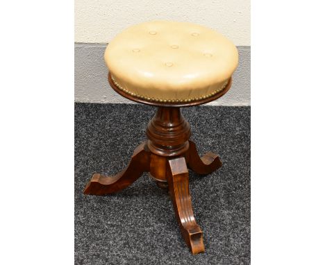 A REVOLVING MUSIC STOOL with studded leather and buttoned circular top on tripod supports