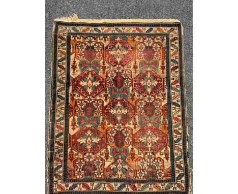 An antique Afghanistani/ Persian rug, central panel of interconnected geometric floral medallions. upon a red and cream groun