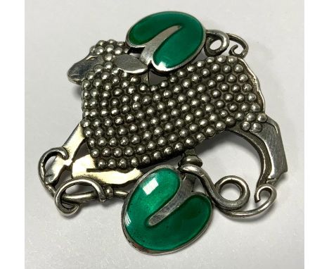 Georg Jensen style, a Danish silver and enamel pierced brooch, a lamb with green enamel leaves above and below, stamped 925 S